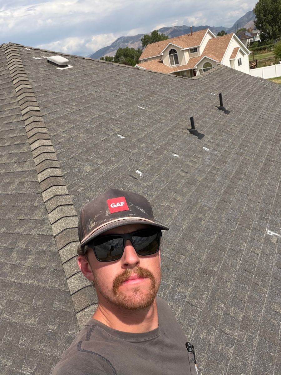 Spencer on a roof with creased shingles numbered in chalk