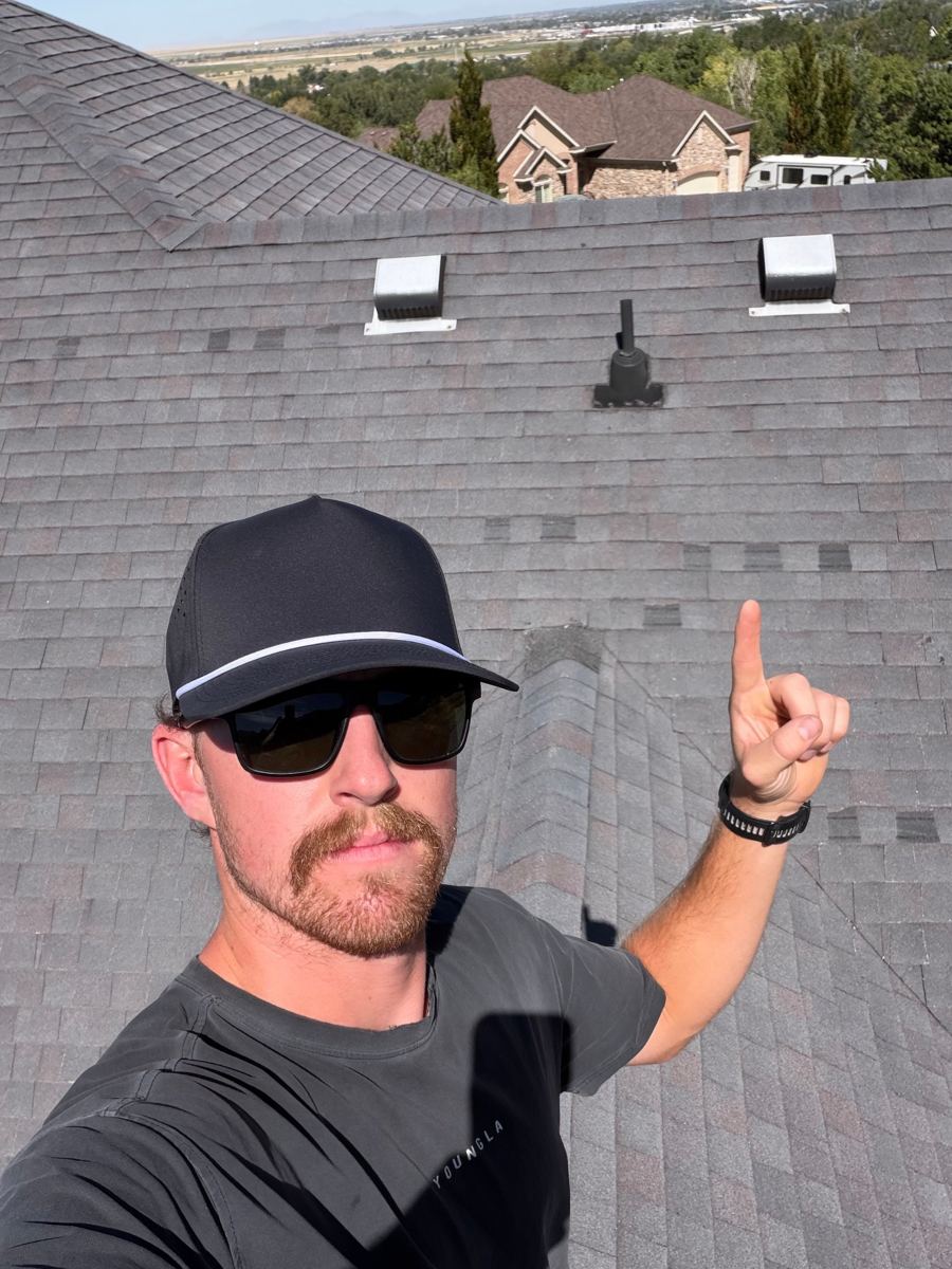Roof with missing and mismatched patched shingles after a wind storm
